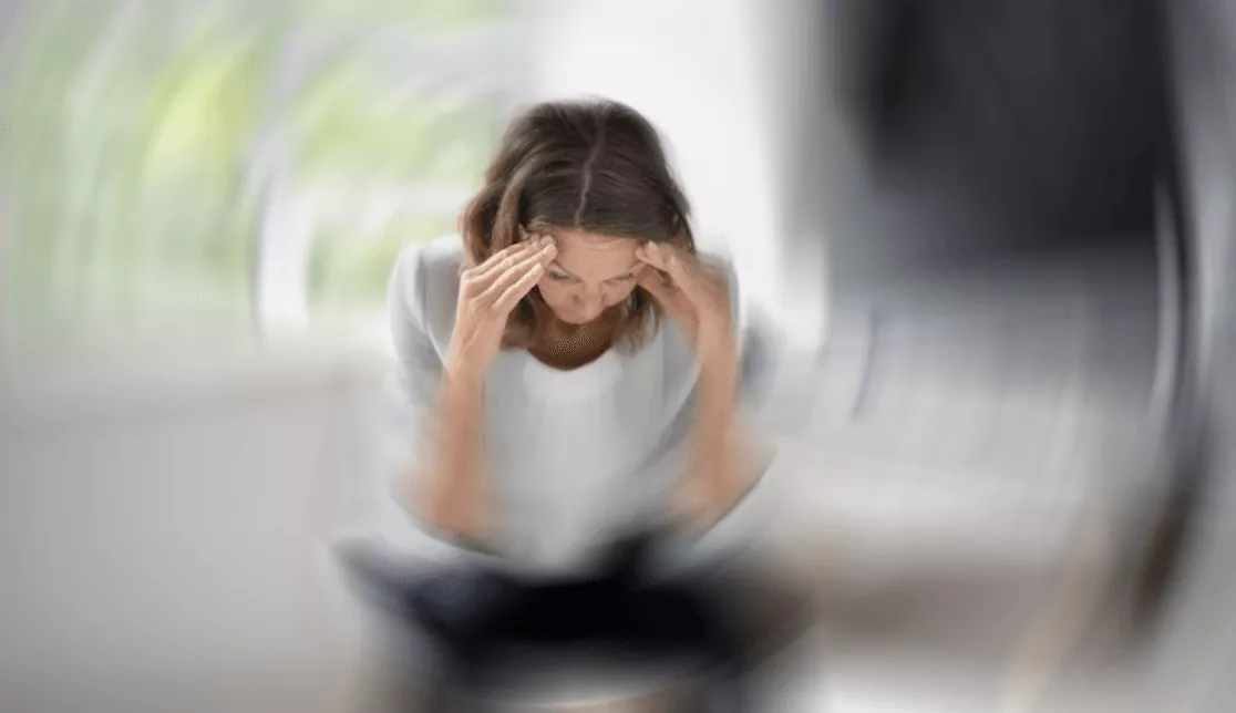 Image of woman experiencing pain and dizziness